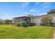 Spacious backyard with screened porch and lush landscaping at 274 Paradise Island Dr, Haines City, FL 33844