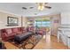 Spacious living room with lake view, comfortable seating, and hardwood floors at 274 Paradise Island Dr, Haines City, FL 33844