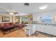 Bright kitchen with white cabinets, granite countertops, and hardwood floors at 274 Paradise Island Dr, Haines City, FL 33844