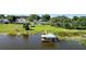 Aerial view of a lakeside home with private dock and boathouse at 274 Paradise Island Dr, Haines City, FL 33844