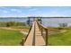 Wooden dock and gazebo extending over calm lake waters at 274 Paradise Island Dr, Haines City, FL 33844