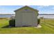 Tan storage shed in backyard, near lake at 274 Paradise Island Dr, Haines City, FL 33844