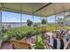 Relaxing screened porch with lake view, wooden furniture, and string lights at 274 Paradise Island Dr, Haines City, FL 33844