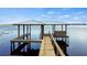 Wooden dock with covered seating area on the lake at 274 Paradise Island Dr, Haines City, FL 33844