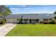 Single story home with attached garage, covered porch, and lake view at 274 Paradise Island Dr, Haines City, FL 33844