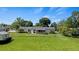Large grassy backyard with a shed and privacy fence at 274 Paradise Island Dr, Haines City, FL 33844