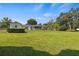 Large backyard with spacious grassy area, detached shed, and fenced perimeter at 274 Paradise Island Dr, Haines City, FL 33844