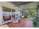 Screened porch with lake view and comfortable seating area at 274 Paradise Island Dr, Haines City, FL 33844