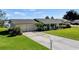 Charming ranch home with a two-car garage and manicured lawn at 274 Paradise Island Dr, Haines City, FL 33844