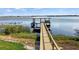 Wooden dock extending into lake with covered seating area at 274 Paradise Island Dr, Haines City, FL 33844