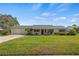 Single story home with attached two-car garage, covered porch, and landscaping at 274 Paradise Island Dr, Haines City, FL 33844