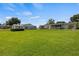 Large grassy backyard with a storage shed and home view at 274 Paradise Island Dr, Haines City, FL 33844