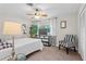 Bright bedroom with full-size bed and a striped chair at 274 Paradise Island Dr, Haines City, FL 33844
