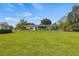 Large backyard with a spacious grassy area and home view at 274 Paradise Island Dr, Haines City, FL 33844