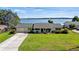 Single story home with lake view, large yard, and long driveway at 274 Paradise Island Dr, Haines City, FL 33844
