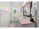 Simple bathroom with a pink countertop and a large mirror at 274 Paradise Island Dr, Haines City, FL 33844