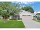 Cute one-story home with pink garage door and well-manicured lawn at 1805 Masters Ln, Lakeland, FL 33810