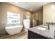 Spa-like bathroom with soaking tub, walk-in shower, and granite vanity at 3671 E Gaskins Rd, Bartow, FL 33830