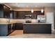 Modern kitchen with dark cabinets, granite countertops, stainless steel appliances, and an island at 3671 E Gaskins Rd, Bartow, FL 33830