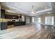 Open concept kitchen features dark cabinetry, granite countertops, and stainless steel appliances at 3671 E Gaskins Rd, Bartow, FL 33830