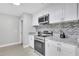 Modern kitchen with white cabinets, granite counters and stainless steel appliances at 724 Hillside Ave, Lake Wales, FL 33853