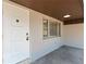 Inviting front porch with a white door and light gray walls at 724 Hillside Ave, Lake Wales, FL 33853
