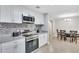Modern kitchen with white cabinets, granite countertops and stainless steel appliances at 724 Hillside Ave, Lake Wales, FL 33853