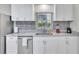 Clean kitchen with white cabinets, granite counters, and stainless steel appliances at 724 Hillside Ave, Lake Wales, FL 33853