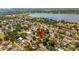 Aerial view of a house nestled in a quiet residential neighborhood near a lake at 724 Hillside Ave, Lake Wales, FL 33853