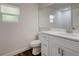 Clean bathroom with single vanity and updated toilet at 318 Senate St, Auburndale, FL 33823