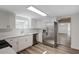 Updated kitchen with stainless steel appliances and white cabinets at 318 Senate St, Auburndale, FL 33823