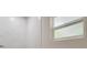 Shower with marble tile and a window for ventilation at 318 Senate St, Auburndale, FL 33823
