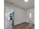 View of kitchen and dining room with wood-look floors at 318 Senate St, Auburndale, FL 33823
