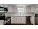 Modern kitchen with white cabinets and stainless steel appliances at 318 Senate St, Auburndale, FL 33823