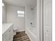 Clean bathroom featuring a shower/tub combo and white vanity at 318 Senate St, Auburndale, FL 33823