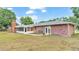 Brick home with a large backyard and sunroom at 3479 Arrowwood Dr, Lakeland, FL 33811