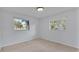 Bedroom with two windows and carpet flooring at 3479 Arrowwood Dr, Lakeland, FL 33811