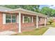 Brick home with covered porch and white columns at 3479 Arrowwood Dr, Lakeland, FL 33811