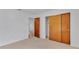 Bedroom with wood closet doors and carpet at 3479 Arrowwood Dr, Lakeland, FL 33811