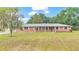 Brick ranch home with a spacious lawn and mature trees at 3479 Arrowwood Dr, Lakeland, FL 33811