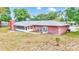 Back exterior view of brick house with screened porch and large yard at 3479 Arrowwood Dr, Lakeland, FL 33811