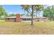 Brick house back exterior view, showcasing a large screened porch and spacious yard at 3479 Arrowwood Dr, Lakeland, FL 33811