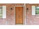 Ornate wood front door on a brick home at 3479 Arrowwood Dr, Lakeland, FL 33811