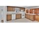 Bright kitchen with wood cabinets, white appliances, and tile flooring at 3479 Arrowwood Dr, Lakeland, FL 33811