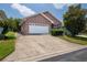 Attached garage with a white door and a brick exterior at 6118 Silver Lakes W Dr, Lakeland, FL 33810