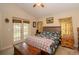 Bright bedroom with floral bedding and French doors leading to the backyard at 6118 Silver Lakes W Dr, Lakeland, FL 33810