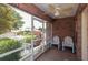 Brick screened porch with two comfy chairs, overlooking the neighborhood at 6118 Silver Lakes W Dr, Lakeland, FL 33810