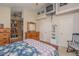 Main bedroom with floral bedding, built-in shelving, and rocking chair at 6118 Silver Lakes W Dr, Lakeland, FL 33810