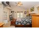 Main bedroom with floral bedding, ceiling fan, and access to backyard at 6118 Silver Lakes W Dr, Lakeland, FL 33810