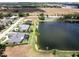 Aerial view of lakefront home with pool and dock at 745 Square Lake E Dr, Bartow, FL 33830
